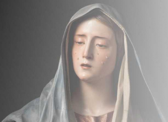 A sculpture of Mary weeping.