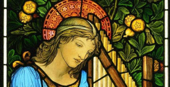 A stained glass window featuring Saint Cecilia with a pipe organ.