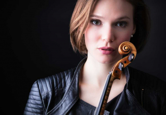 Tamsin Waley-Cohen holding her violin