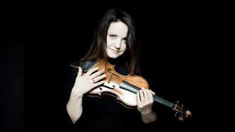 Baiba Skride holding her violin.