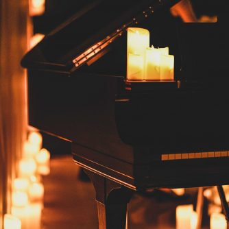A piano with candles on it