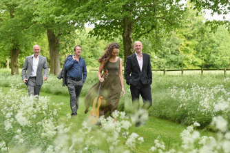 Vida Guitar Quartet walking through a garden