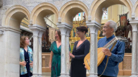 Jane, Alice, Carmel and Din seen through cloister columns